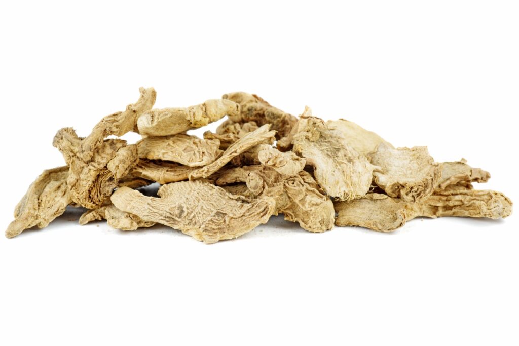 Small pile of dried ginger slices isolated on white background